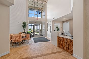 a lobby with a reception desk and a table with chairs